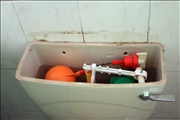 Toilet cestern with a block that was dropped by one of the water agent 